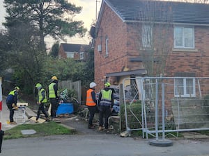 Workers on site after a BMW car smashed into a house in Ketley Telford.