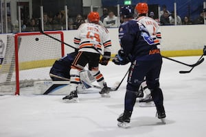 The puck hits the back of the Sharks' net