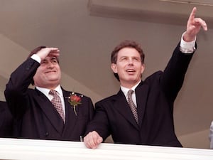 John Prescott, left, shields his eyes as Tony Blair points towards something