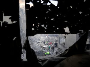 Rescue workers and people search for victims at the site of an Israeli airstrike that hit central Beirut