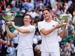 Henry Patten, right, and Harri Heliovaara with their Wimbledon trophies