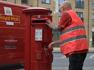 Royal Mail worker at a post box