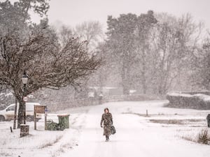 Woman walking through snow