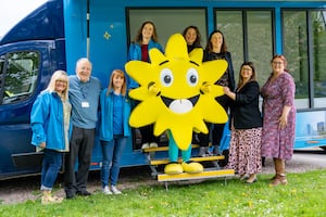 The charity's staff, volunteers and mascot Sunny.