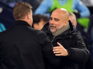 Manchester City manager Pep Guardiola speaks with Salford City manager Karl Robinson