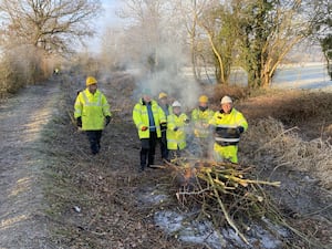 Volunteers keeping warm by the bonfire. Photo: Shropshire Union Canal Society