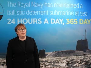 Maria Eagle in front of a sign highlighted the nuclear deterrent