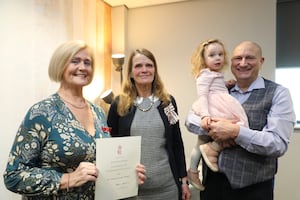 Heather Wenban (left) is pictured at the ceremony at Newtown where she was presented with the British Empire Medal by the Lord Lieutenant Mrs Tia Jones (second from left) and Heather’s husband Paul and grand-daughter Edie. 