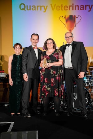 Neil Williams and Lindsey Jones (centre), clinical directors of Quarry Vets, receive the trophy at the awards ceremony in Manchester.