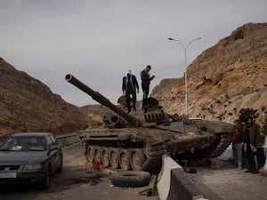 Fighters standing on top of a tank