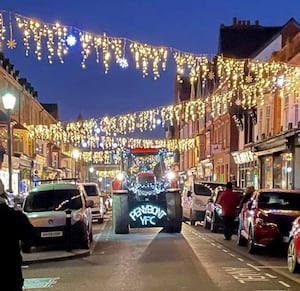 An illuminated tractor coming through Llandrindod Wells in a previous event