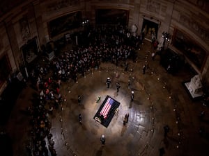 President-elect Donald Trump and Melania Trump pause at the flag-draped casket of former US president Jimmy Carter as he lies in state in the rotunda of the US Capitol in Washington