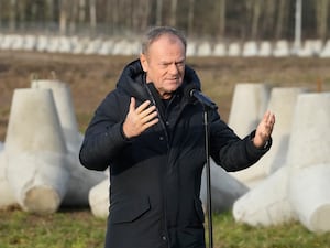 Donald Tusk gesturing as he makes a speech