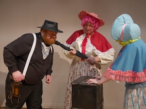 Getting to grip with Billy the Skid is ugly sister Spitunia played by Graham Rimmer while Salivia watches on. Image: Andy Compton