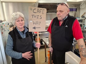 Debbie and John Johnson at the Heath Hill Cafe - Bostin Fittle - with a makeshift sign on the end of a broom handle. Picture: LDRS