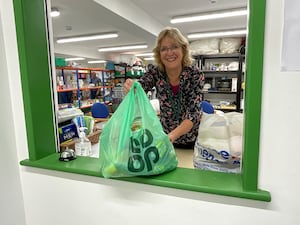 A volunteer handing out a food parcel at Llandrindod Foodbank.