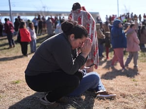 Dasia Pleitez prays as she waits for her daughter at a unification site following a shooting at the Antioch High School in Nashville