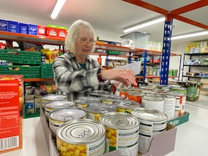 Tessa Bradley, Llandrindod Foodbank and Advice Centre Project Manager picking a food parcel.