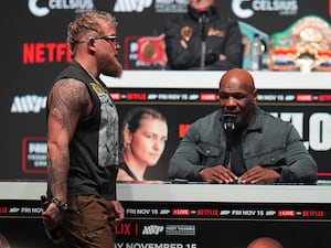 Mike Tyson looks on as Jake Paul walks on stage