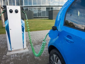 A blue electric car being charged