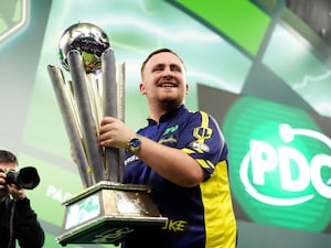 Luke Littler with the Sid Waddell Trophy after beating Michael van Gerwen 7-3 at Alexandra Palace