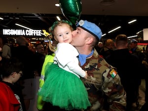 A soldier kissing his daughter