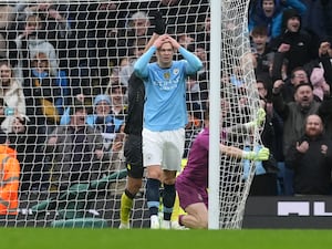 Erling Haaland stands dejected after missing a penalty,