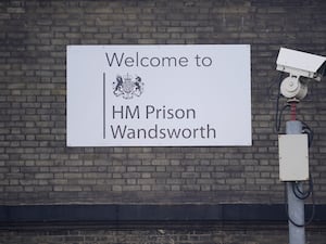 A CCTV camera and sign outside HMP Wandsworth