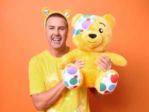 Paddy McGuinness holding a Pudsey bear