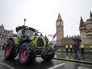 Tractor driving on a London road with Big Ben in the background