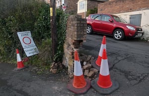 Pic in Ironbridge, Church Hill at the junction with New Road, where a vehicle has damaged an old historic wall.