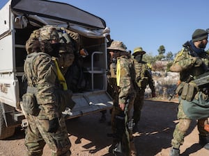 Syrian opposition fighters enter a village