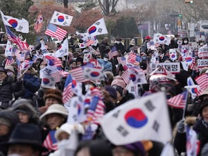 Supporters of impeached South Korean President Yoon Suk Yeol shout slogans during a rally near the Constitutional Court in Seoul