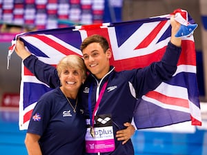 Great Britain’s Tom Daley celebrates with his coach Jane Figueiredo after winning gold in the 3m Synchro Diving Mixed Final during day three of the European Aquatics Championships at the London Aquatics Centre in Stratford.