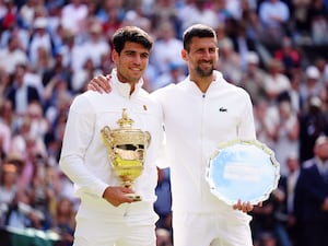 Carlos Alcaraz, left, and Novak Djokovic with their Wimbledon trophies