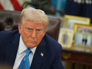 President Donald Trump speaks to reporters as he signs executive orders in the Oval Office of the White House in Washington