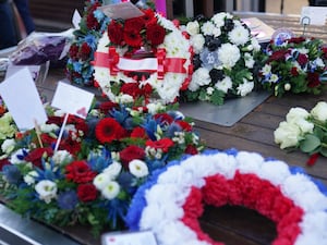 Wreaths are laid during a memorial service at 1000 Trades Square, outside New Street station in Birmingham to mark the 50th anniversary of Birmingham pub bombings