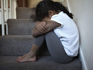 A child sitting on some stairs