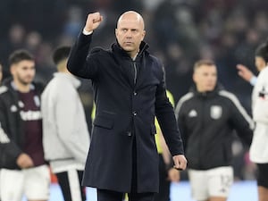 Arne Slot clenches his right fist to celebrate in front of the Liverpool fans