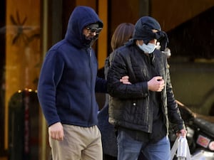 Two men with face masks and hats