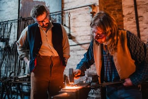 Blacksmith showing participant how to hammer at the Blacksmith Experience Day at Blists Hill Victorian Town