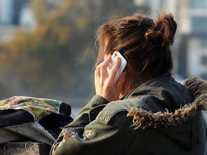 A woman using a mobile phone in central London