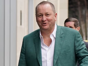 Mike Ashley walking along street