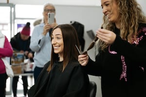 Shrewsbury Hair Salon, Hair on the Hill in Bayston Hill, held a charity day raising money for Cancer Research and Little Princess Trust. One of the staff members, Chantel, had her hair cut and has donated it. Owner Danni Redding cuts Chantel Boulton's hair for charity.