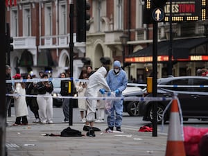 Forensic investigators collect evidence at the scene