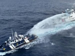 A Chinese coast guard vessel fires a powerful water cannon on a Philippine bureau of fisheries vessel near a disputed shoal in the South China Sea