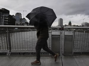 A person struggles with their umbrella as the wind picks up in Dublin’s city centre