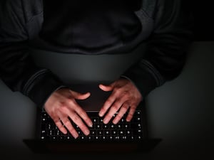 Man's hands on a laptop keyboard