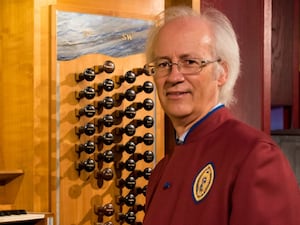 Michael Harris sitting in front of an organ