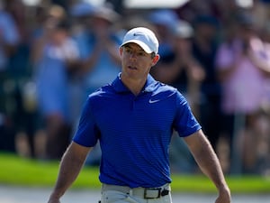 Rory McIlroy of Northern Ireland walks after scoring a birdie on the ninth green in the final round of World Tour Golf Championship